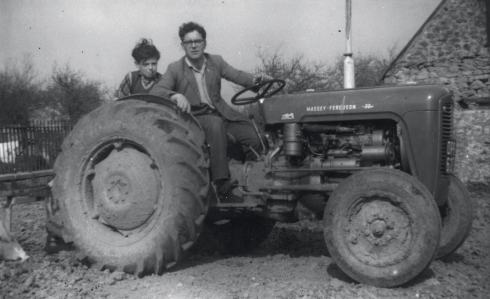 Les (and a nephew) with his first tractor, which he bought in 1960