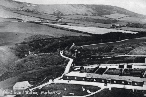 Worbarrow Coastguard Station, showing its black-painted range of single storey buildings. Although this view was taken in 1905, it would have been instantly recognisable to George Grebbell, Phoebe’s father.
