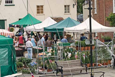 The Saturday morning market, seen through the rigging of boats moored alongside