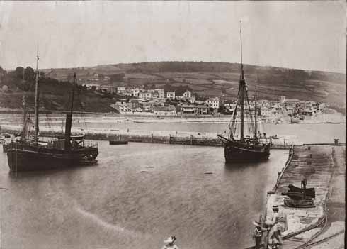 Sail and steam meet in the harbour in about 1890
