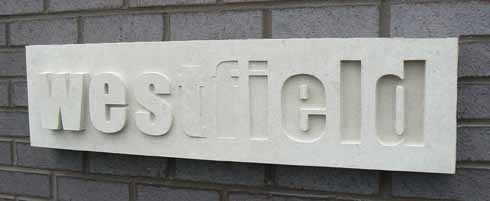 This sign for Westfield Technology College, Weymouth, is Portland stone and is an example of raised and sunken lettering 