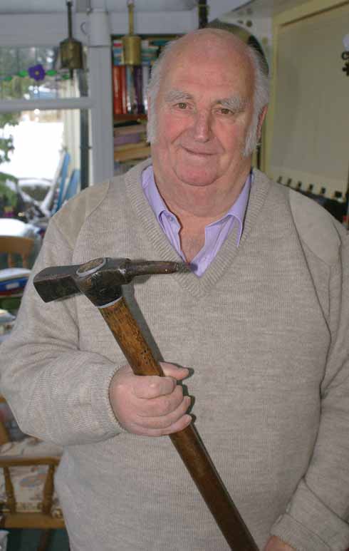 Larry Skeats holding a knock hammer – the precursor of today’s abattoir stun-guns