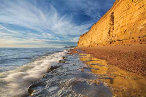 211edEDWARDES14 The towering golden sandstone cliffs between Burton Bradstock and West Bay are familiar landmarks of the Jurassic Coast