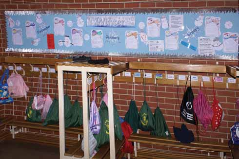 Every usable inch of wall space is used to reinforce the formal classroom lessons. Here poetry, pupils’ written work and related information all subliminally inform as the children take off and put on their coats.