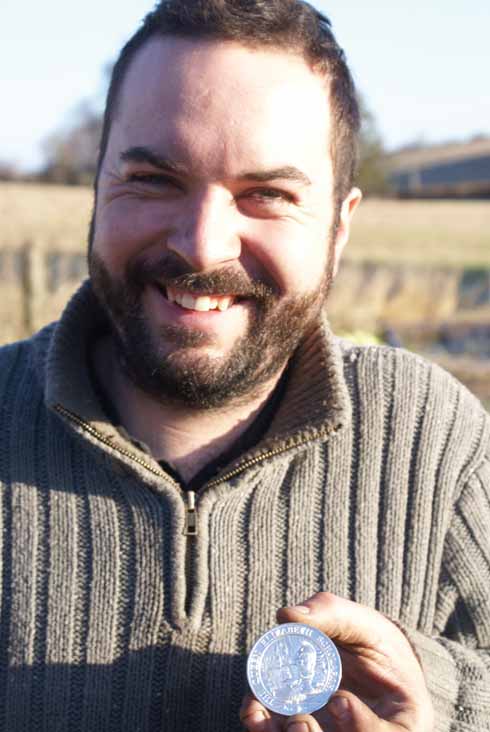 Adam Greenwell with his solid silver Queen Elizabeth Trust medal