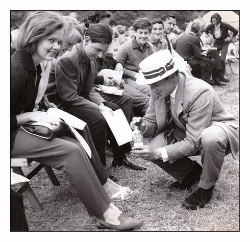 Members of the audience having their bites tended to with TCP before watching Brownsea Open Air Theatre's production of The Tempest in 1964