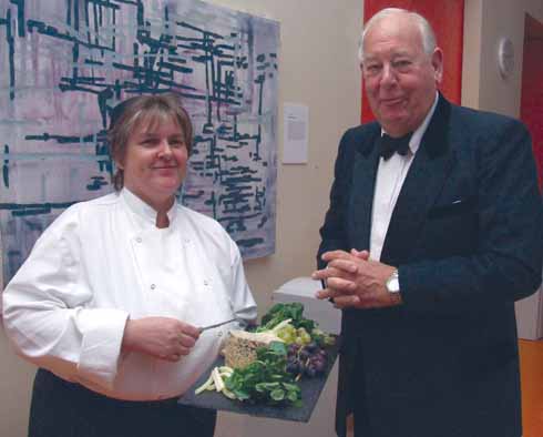 One of the enduring traditions of The Society of Dorset Men is the parading of the Dorset Blue Vinny cheese to the President's table, which Sir Anthony tastes and pronounces fit to eat! Here at the 2009 County Dinner at Sherborne School, chef Denise Sullivan presents the cheese for inspection.