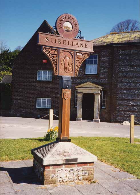 511edLegg1 Winterborne Stickland’s village sign shows the village’s name as Winterburn Stikellane, which is how it was known in the year 1203