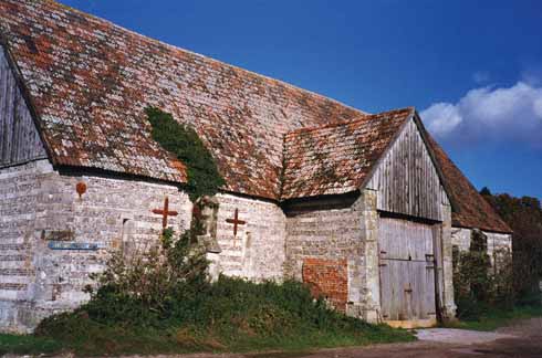 511edLegg3 According to Pevsner, some of this banded flint-and-stone barn’s roof trusses were possibly recycled from the dissolved Milton Abbey in the 16th century