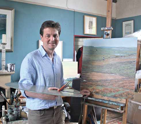 Andrew Stock in his studio, at work on a painting 