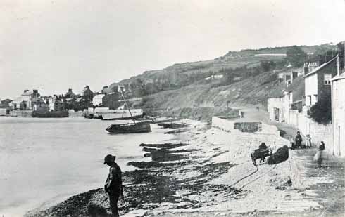 The Walk in 1857, with a wrecked ship driven out of the Cobb by a storm. Cobb Hamlet (in the background), and West Fort still survive.