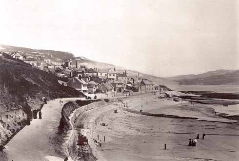 The Walk looking eastwards in the 1870s with the cart road below it. In the near distance is a cart, but it is moving too quickly for the camera to have captured it crisply.  Courtesy Lyme Regis Philpot Museum