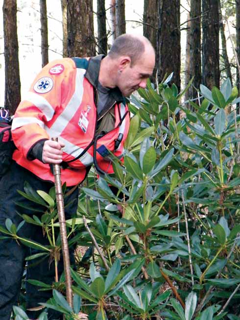 Phil Robinson, head of DorSAR’s tracking competency group, looks for the smallest sign that someone has passed this way