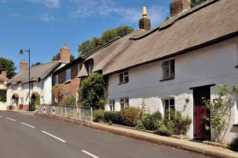 Looking west along Main Road, the village’s primary thoroughfare, showing a mixture of cob and thatch, Victorian brick-built cottages and  sympathetically designed new-build housing