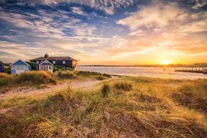 Mudeford Spit sunset. A week before the summer solstice, the sun sets nearly in the North-West at 310° on the compass. This shot, taken an hour before sunset from near the north-eastern tip of Mudeford spit, looks west-north-west across Christchurch Harbour but includes the jetty from the eastern side of the harbour mouth.